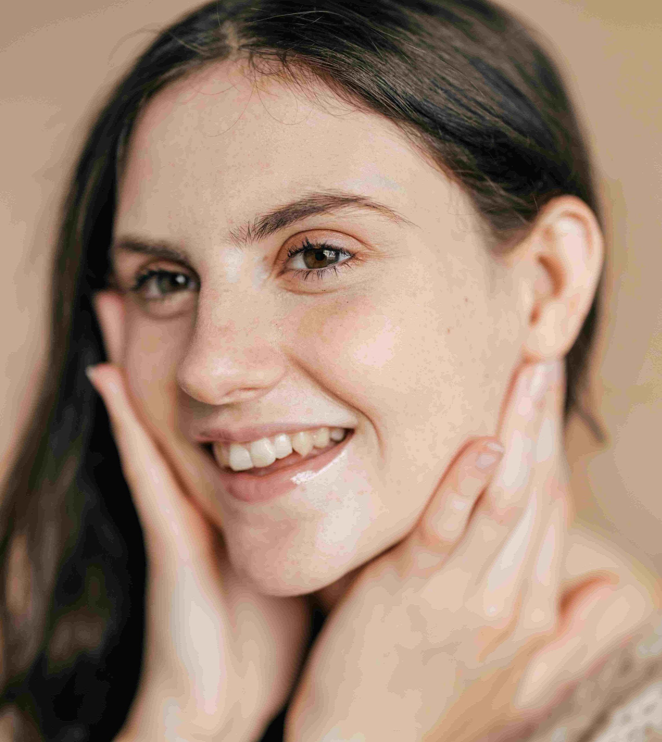 Young woman cupping her face with her hands