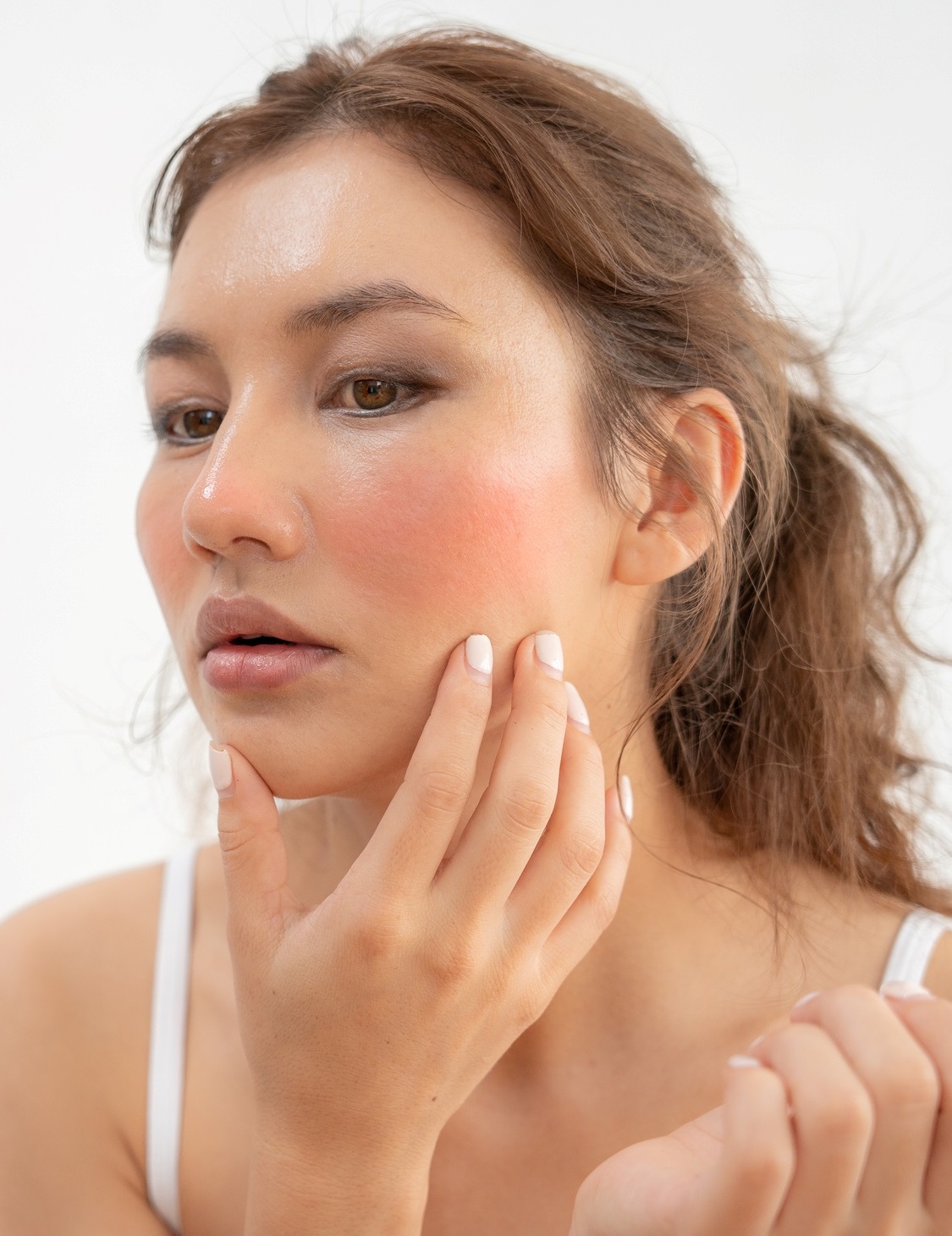 Young gorgeous Eurasian woman with red cheeks